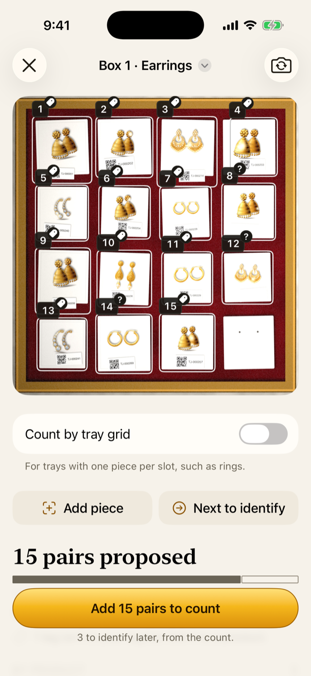 The review of a tagged box of earrings, each piece marked and numbered.